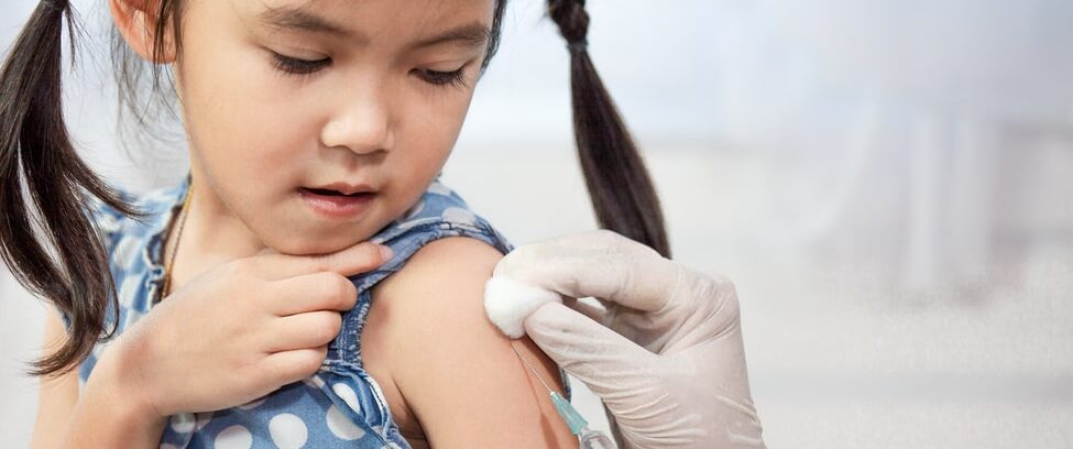 Young girl getting flu shot.